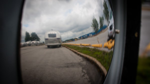 Reflection of an Airstream from the hub cap of another Airstream.